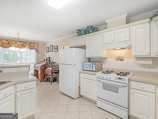 kitchen with light tile patterned floors, white appliances, ornamental molding, white cabinets, and decorative light fixtures