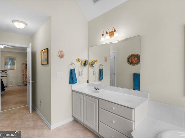 bathroom featuring vanity, tile patterned floors, a tub, and ceiling fan