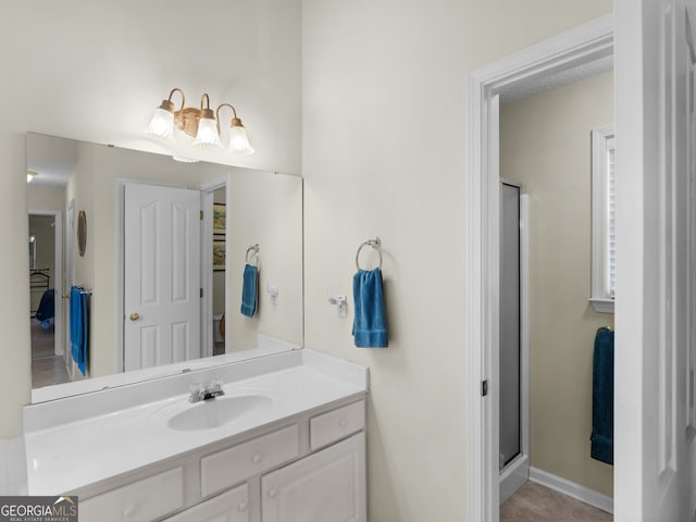 bathroom featuring vanity and an enclosed shower