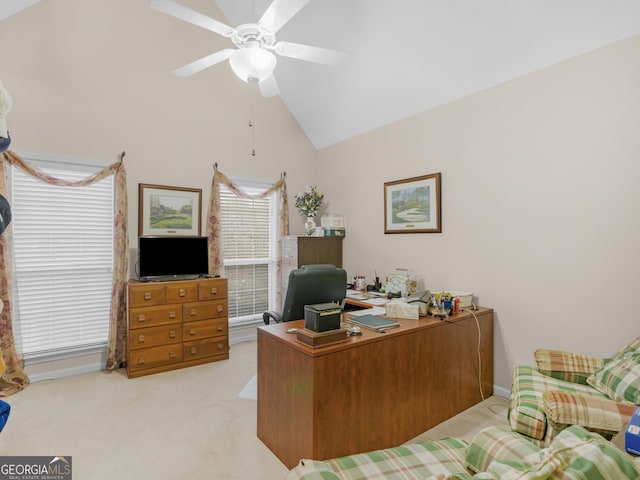 carpeted office space with ceiling fan and high vaulted ceiling