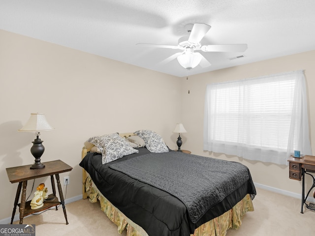 bedroom with ceiling fan and light colored carpet