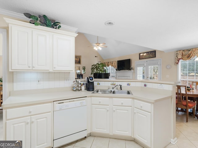 kitchen featuring dishwasher, sink, kitchen peninsula, and white cabinets