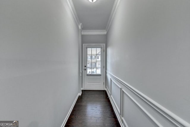 entryway with ornamental molding and dark hardwood / wood-style flooring