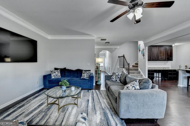 living room with ornamental molding, ceiling fan, and dark hardwood / wood-style flooring