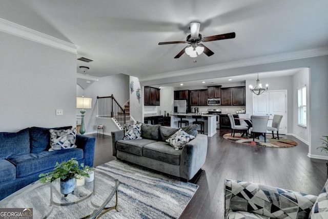 living room featuring ceiling fan with notable chandelier, ornamental molding, and dark hardwood / wood-style floors