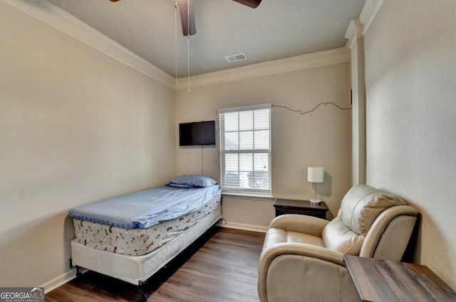 bedroom with ornamental molding, dark hardwood / wood-style floors, and ceiling fan