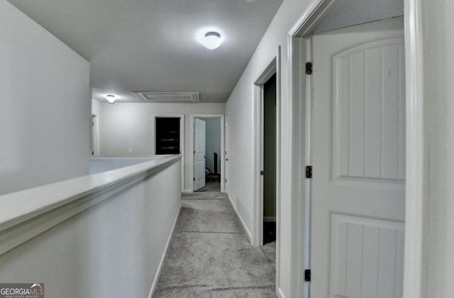 hallway featuring light colored carpet