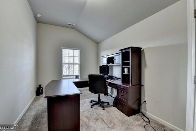 office space with vaulted ceiling and light colored carpet