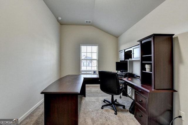 office space featuring light colored carpet and lofted ceiling