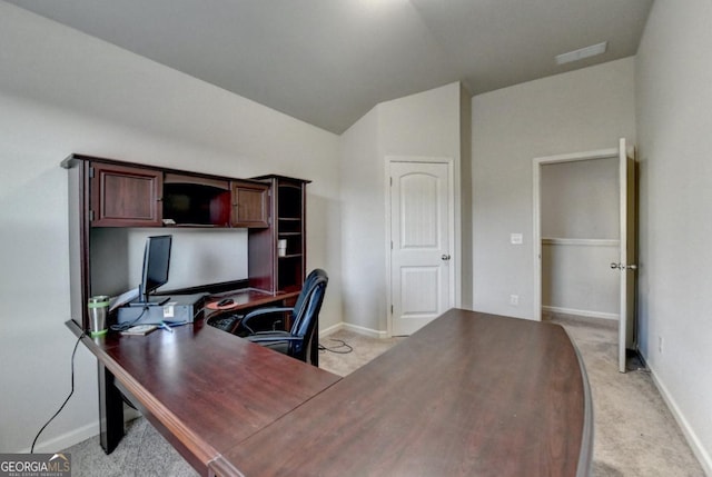 office with light colored carpet and lofted ceiling