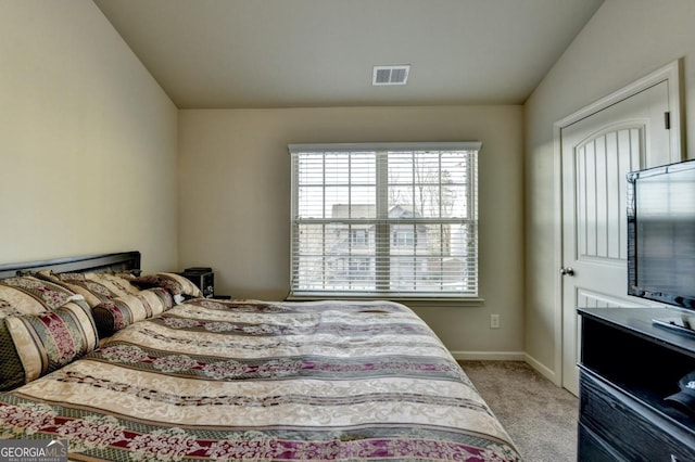 carpeted bedroom featuring lofted ceiling