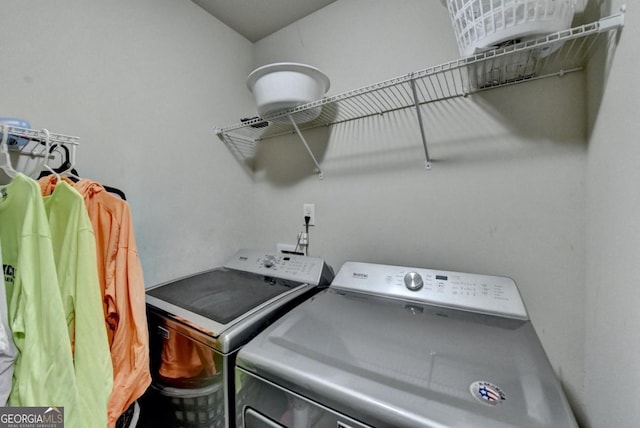 laundry room with washing machine and clothes dryer