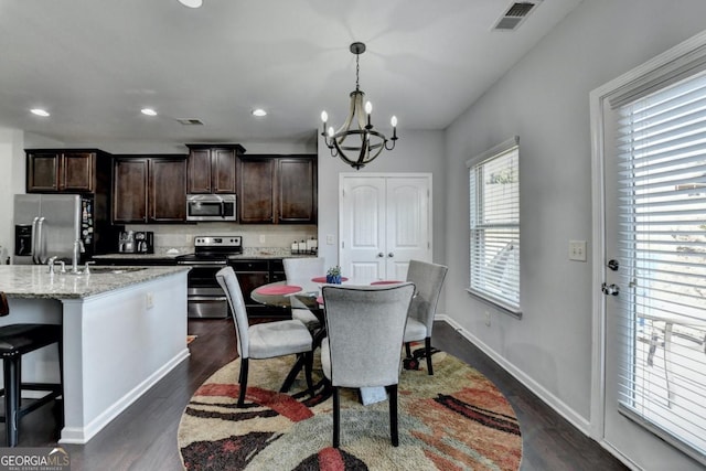 interior space featuring an inviting chandelier, sink, and dark hardwood / wood-style floors