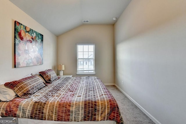 bedroom with vaulted ceiling and carpet floors