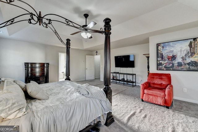 bedroom featuring a raised ceiling, ceiling fan, and carpet flooring