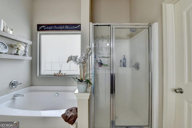 bathroom featuring shower with separate bathtub