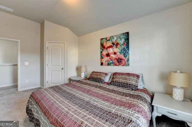 bedroom with carpet and lofted ceiling