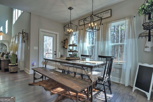 dining room with plenty of natural light and dark hardwood / wood-style flooring