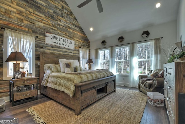 bedroom with dark wood-type flooring, ceiling fan, and high vaulted ceiling