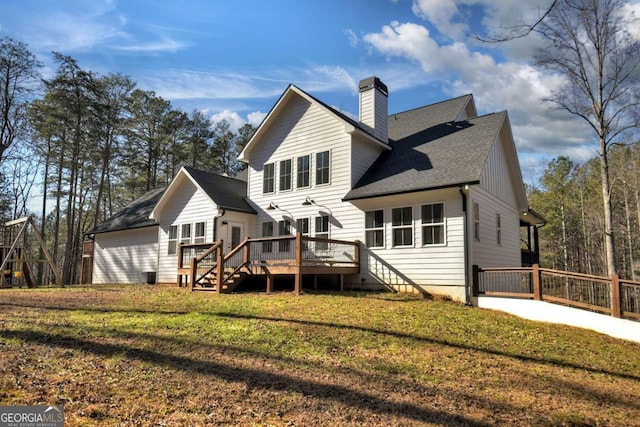 back of house featuring a deck and a lawn