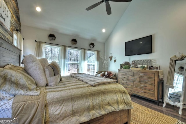 bedroom featuring ceiling fan, dark hardwood / wood-style floors, and high vaulted ceiling