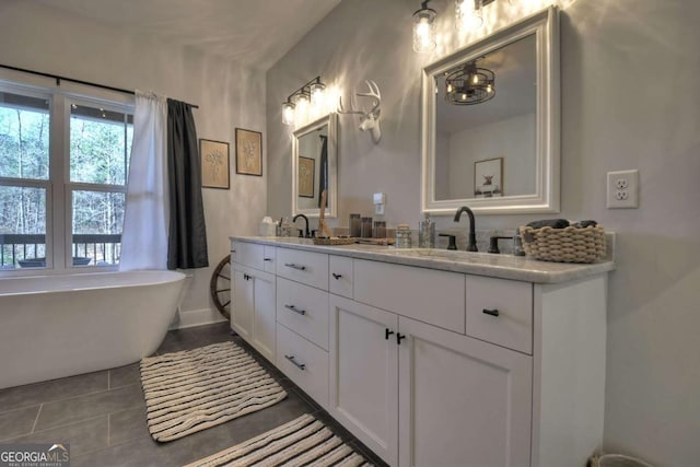 bathroom featuring tile patterned flooring, vanity, and a tub to relax in