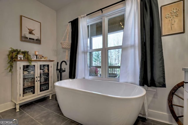 bathroom featuring a washtub and tile patterned floors