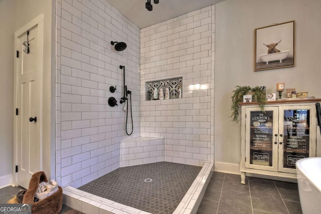 bathroom featuring a tile shower and tile patterned flooring