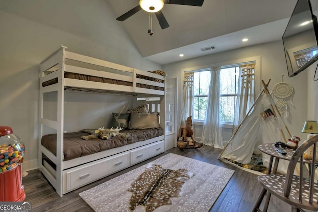 bedroom with dark hardwood / wood-style flooring, vaulted ceiling, and ceiling fan