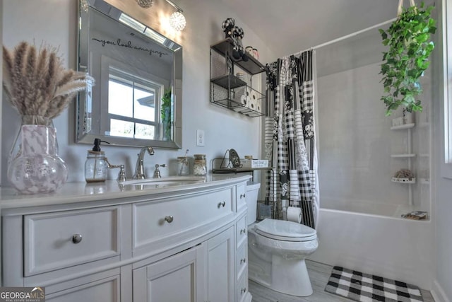 full bathroom with shower / tub combo, vanity, and toilet