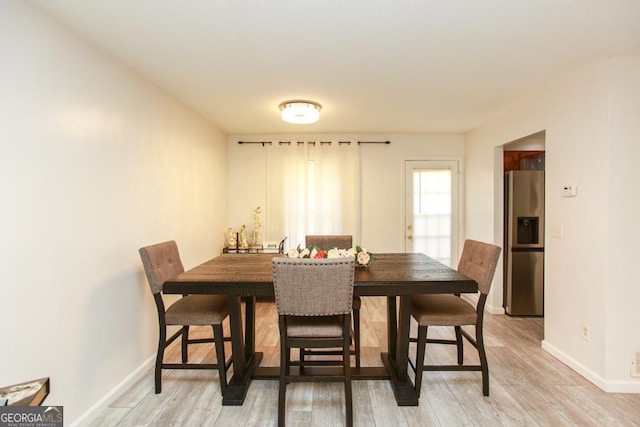 dining space with wood-type flooring