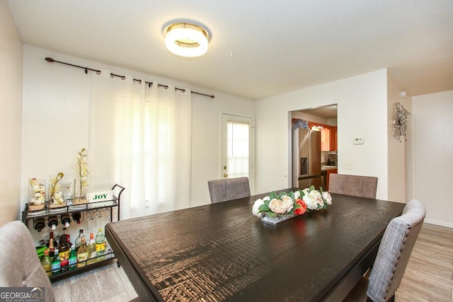 dining space featuring light wood-type flooring