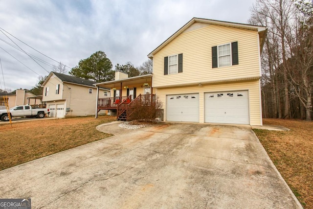 view of front of home featuring a garage, a front lawn, and covered porch