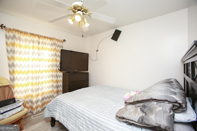 bedroom with hardwood / wood-style floors and ceiling fan