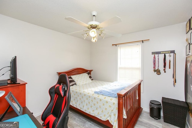 bedroom with ceiling fan and light wood-type flooring