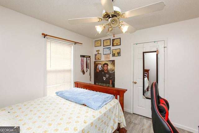 bedroom with ceiling fan and light hardwood / wood-style flooring