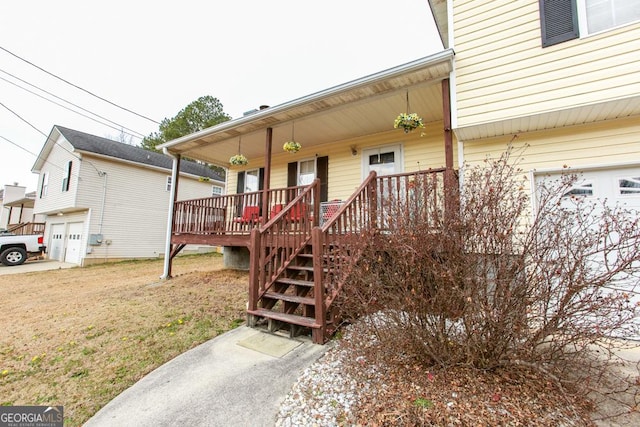 exterior space featuring a garage, a porch, and a yard