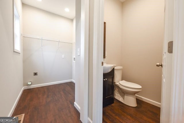 bathroom featuring vanity, hardwood / wood-style floors, and toilet