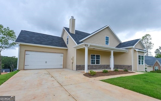 view of front of home featuring a garage, a front lawn, and a porch