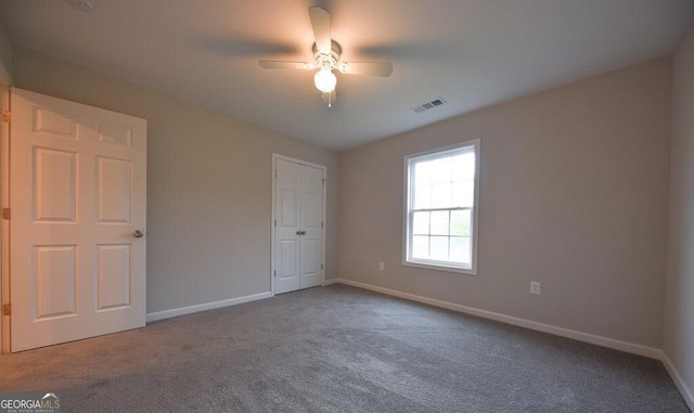 unfurnished bedroom with ceiling fan and carpet floors