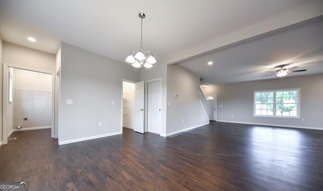 interior space featuring dark wood-type flooring and ceiling fan with notable chandelier