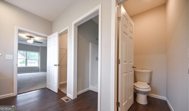 bathroom with wood-type flooring, ceiling fan, and toilet