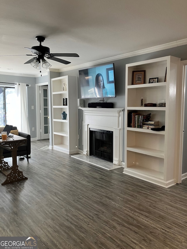 living room featuring dark wood-type flooring, ornamental molding, and ceiling fan