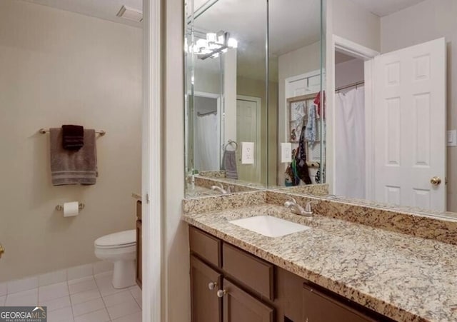 bathroom featuring vanity, tile patterned floors, and toilet