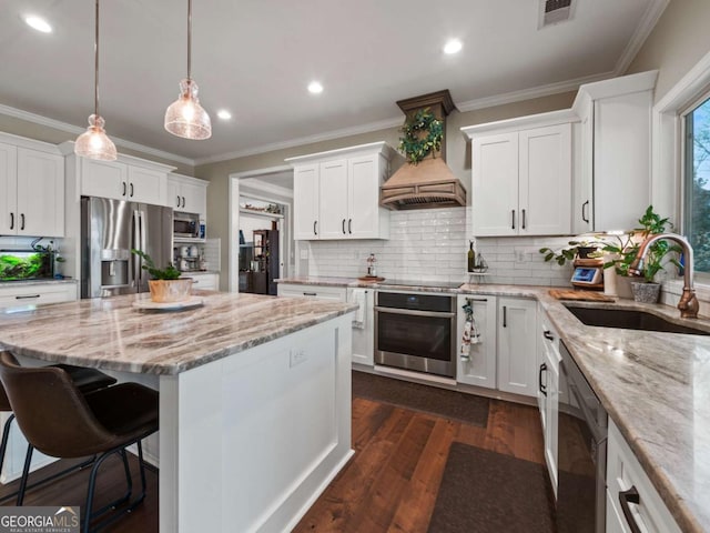 kitchen with pendant lighting, sink, white cabinetry, black appliances, and custom exhaust hood