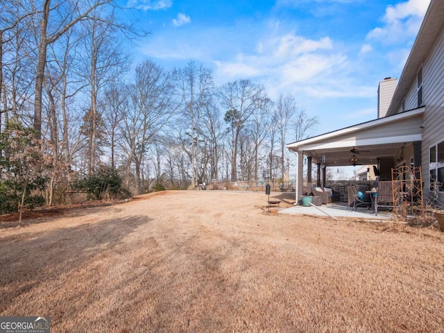 view of yard with a patio and ceiling fan