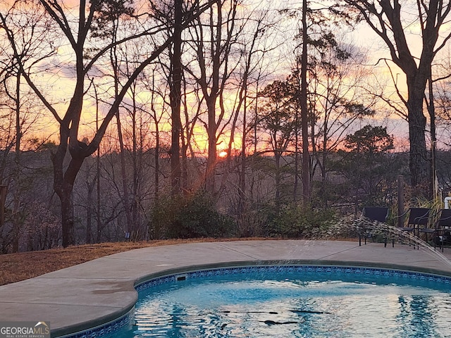 view of pool at dusk