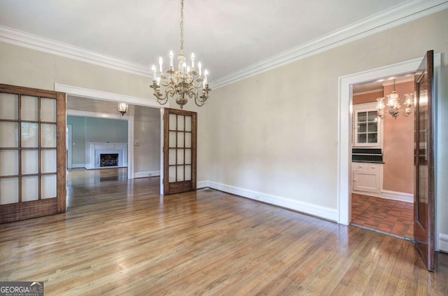 interior space featuring crown molding, wood-type flooring, and an inviting chandelier