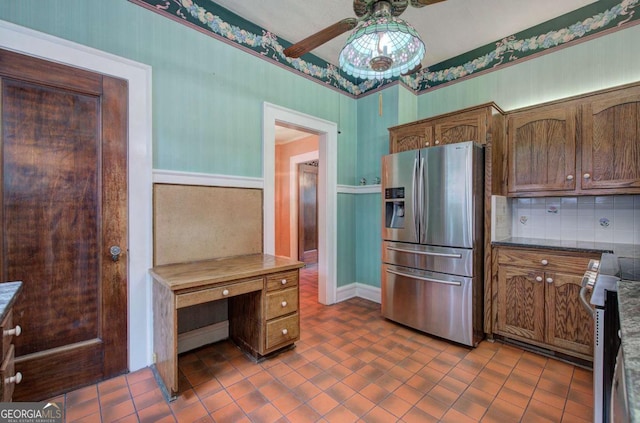 kitchen featuring backsplash, stainless steel appliances, ceiling fan, and dark tile patterned flooring