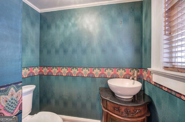 bathroom featuring ornamental molding, vanity, and toilet